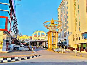 a street with a tower in the middle of a city at Amaris Hotel Nagoya Hill - Batam in Nagoya