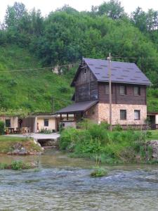 a house on the side of a river at House Marijan in Korana
