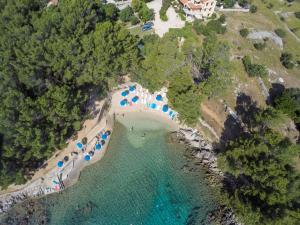 an aerial view of a beach with tents and water at Apartmani Danica in Nerezine