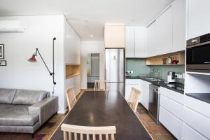a kitchen and living room with a table and a couch at Laanhof Studios in Stellenbosch
