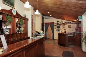a kitchen with wood floors and wooden cabinets at Hotel Il Barocco in Ragusa