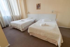 Postel nebo postele na pokoji v ubytování light hotel & hub