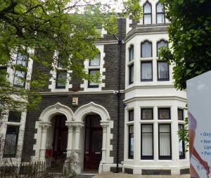 a large house with white trim and a large door at 3 Luxury En-suite Bedrooms in Cardiff