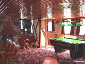 een kamer met een pooltafel in een kamer met stoelen bij The Poldark Inn in Delabole