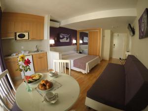 a hotel room with a table and a room with a bed at Ona Princesa Playa in Marbella