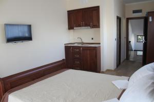 A bed or beds in a room at Compass Aparthotel
