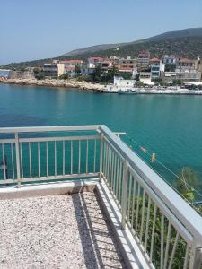 a balcony with a view of a body of water at To Pithari in Skala Marion