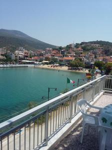 a balcony with a view of a beach and the ocean at To Pithari in Skala Marion