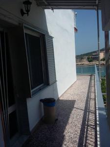 a building with a trash can next to a window at To Pithari in Skala Marion