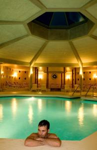 a man in a swimming pool in a hotel at Termeterna Resort in Abano Terme +70 photos
