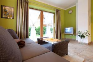 a living room with a couch and a table at Appartementhaus Charisma in Fieberbrunn