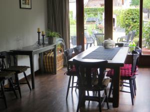 
a kitchen with a table and chairs and a large window at B&B La Grange in Durbuy
