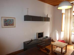 a living room with a television and a table at MOULIN 2 in Barcelonnette