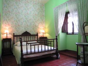 a bedroom with a bed and green walls at Casa Rural Ulibarri in Allo