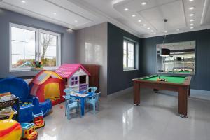 a play room with a pool table and a house at Willa Dalia in Władysławowo