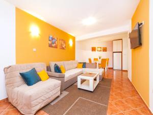 a living room with a couch and a tv at Apartments Spin in Budva