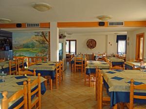 a restaurant with tables and chairs with blue tablecloths at Maso Sveseri in Montesover