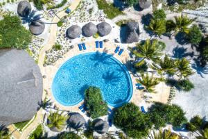an overhead view of a swimming pool with palm trees at Zanzibar Queen Hotel in Matemwe