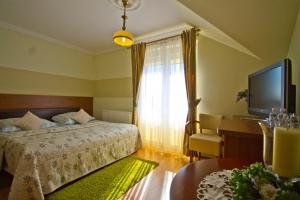 En eller flere senge i et værelse på Villa Tropikana