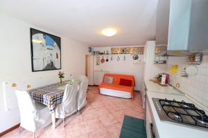 a kitchen with a table and a dining room at La casa del cuore in Temù