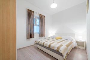 Postel nebo postele na pokoji v ubytování Apartments Miro