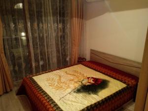 a bedroom with a bed with a flower on it at Sea'n'Pool Apartments in Hotel in Sozopol