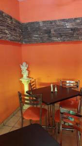 a dining room with a black table and chairs at Hotel La Torre San Francisco in San Francisco del Rincón +61 photos