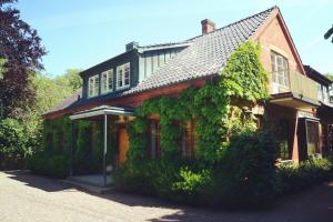 a house with ivy growing on the side of it at Minnesberg Bed & Breakfast in Trelleborg