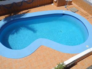 a large blue swimming pool with a tiled floor andizonsizons at Apartamentos Colombia Ap 5 in Puerto del Carmen