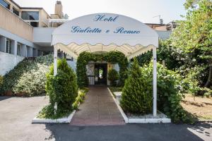an entrance to a house with an arch with a sign at Hotel Giulietta e Romeo in Casal Palocco