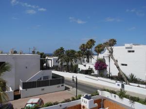 a view of a street with palm trees and buildings at Apartamentos Colombia Ap 5 in Puerto del Carmen