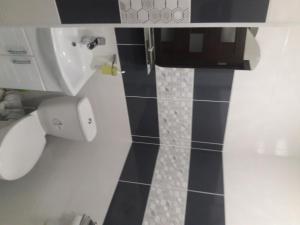 a bathroom with a sink and a toilet at Apartment on Mstyslavs'ka in Chernihiv