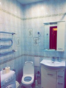 a bathroom with a toilet and a sink and a mirror at Amasing apartment on Dostyk 5 str in Astana