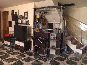 a living room with a staircase and a stool at Casa Lidia și Gogu in Budeasa Mare
