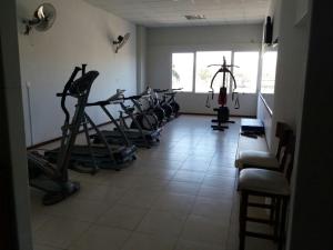 a gym with several tread machines in a room at Hotel Cuatro Plazas in Casilda