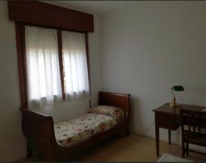Un dormitorio pequeño con una cama y una ventana. en Casa Laguna Venezia, en Lido de Venecia