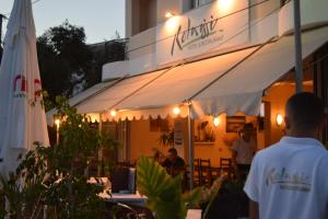 a man standing in front of a restaurant at night at Hotel Kolagji in Himare