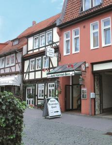 a car parked on the side of a road next to a building at Hotel Deutsches Haus in Northeim