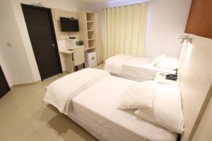 Un ou plusieurs lits dans un hébergement de l'établissement Danieri Asunción Hotel