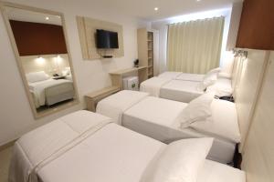 Un ou plusieurs lits dans un hébergement de l'établissement Danieri Asunción Hotel