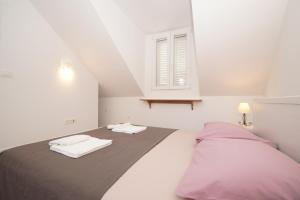 Posteľ alebo postele v izbe v ubytovaní Confluence Apartments