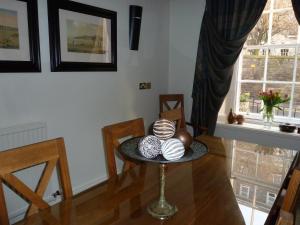 a dining room with a table with balls on it at No 5 Pilmour in St. Andrews