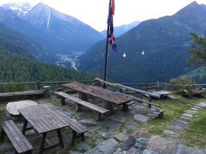 a picnic table with a flag on top of a mountain at Rifugio Guide Frachey in Saint Jacques
