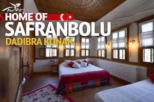 a bedroom with two beds and a sign that reads home of sarantamahoadi at Dadibra Konak Hotel in Safranbolu