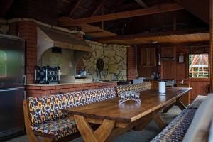 a dining room with a wooden table and chairs at Lodges Zacisze I in Giżycko