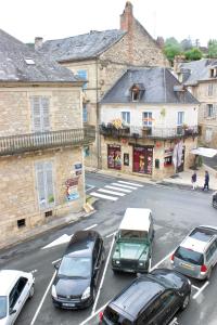 a group of cars parked on a city street at Un Joli Pied a Terre in Montignac