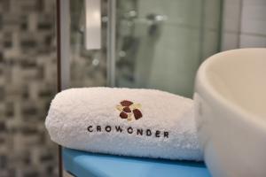 a towel with the word growler sitting on a bathroom counter at Crowonder Luxury Vir- 6 New Apartments for Families with Playground for Kids in Vir