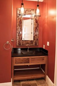 a bathroom with a sink and a mirror at Wishmaker House B&b in Bellville