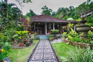 a house with a garden in front of it at Dasa Wana Resort in Candidasa