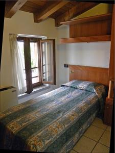a bedroom with a bed and a window at Alla Basilica in Aquiléia